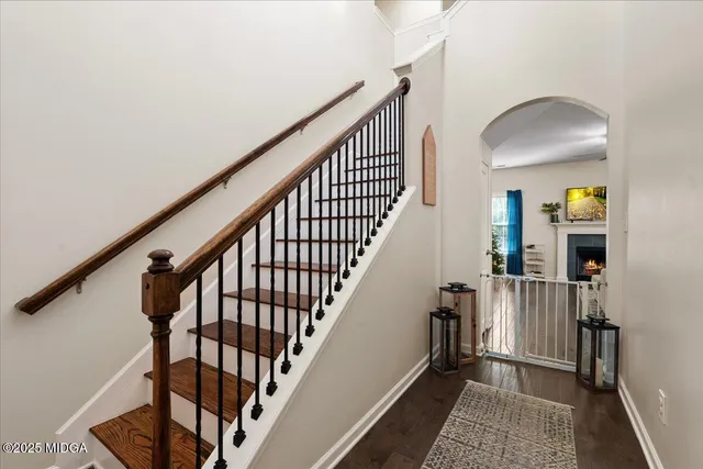 a view of staircase with wooden floor and a rug