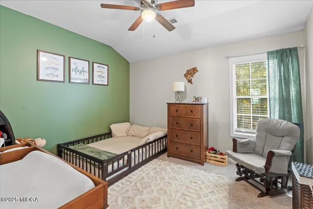 a bedroom with furniture and a window