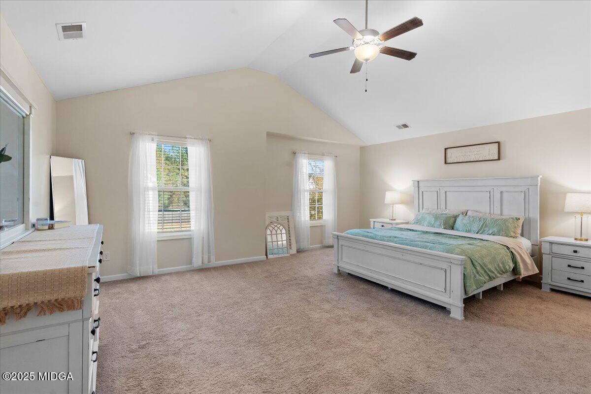108 East E River Perry, GA 31069 - Photo 24 of 38 a spacious bedroom with a bed a chandelier and windows