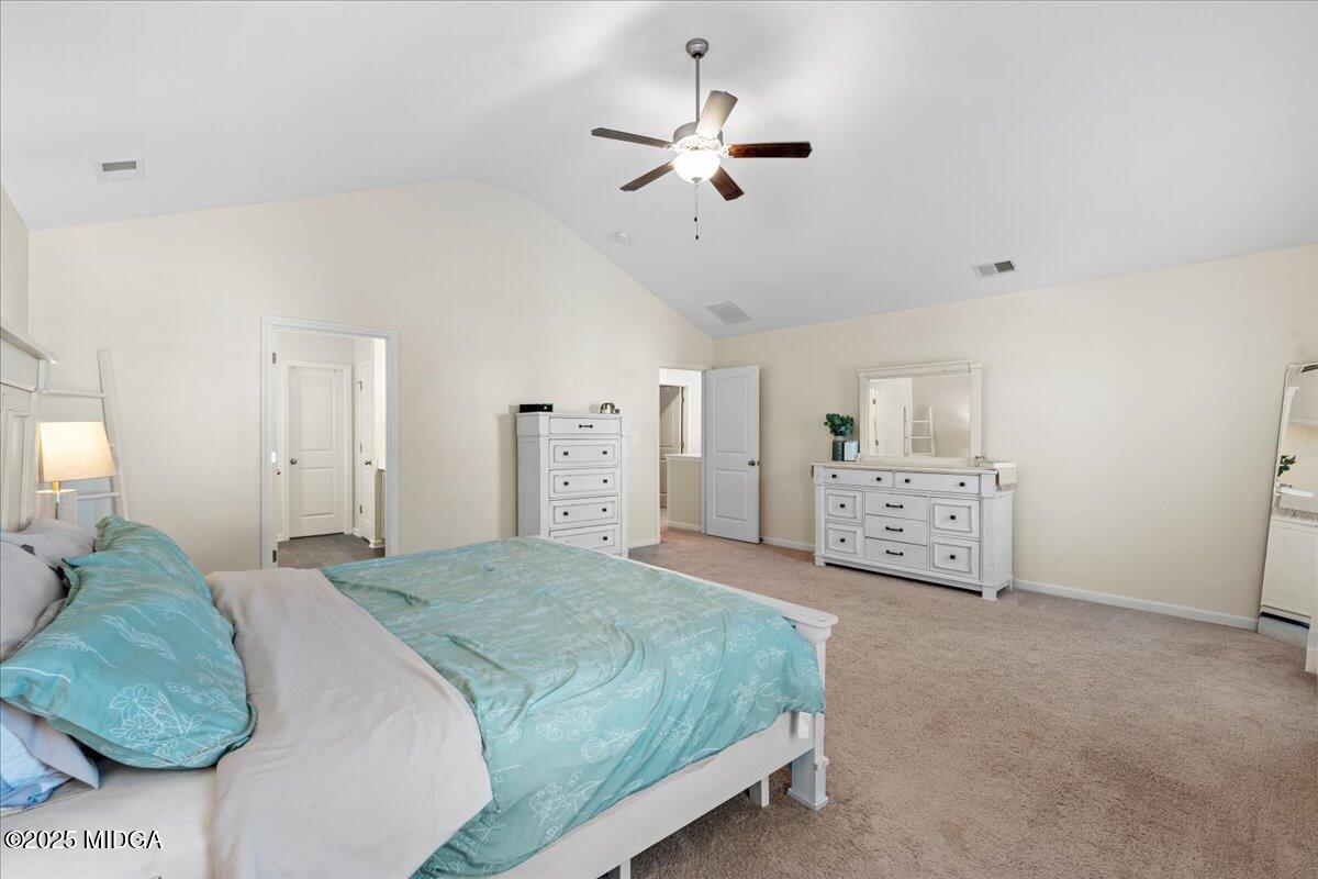 108 East E River Perry, GA 31069 - Photo 26 of 38 a spacious bedroom with a bed and a ceiling fan