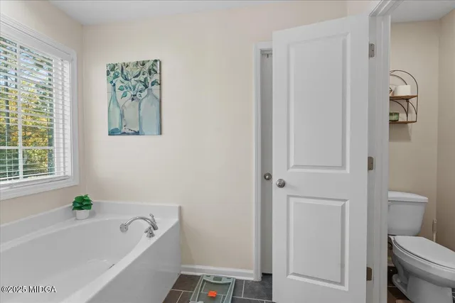 a bathroom with a bathtub a toilet and a shower