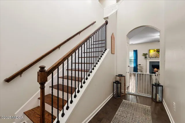 a view of staircase with wooden floor and a rug