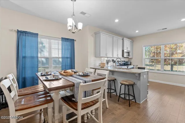 a view of a dining room with furniture window and wooden floor