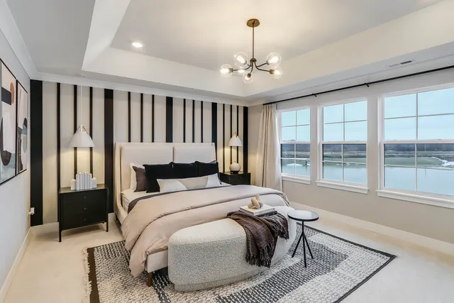 a bed sitting in a bedroom next to a window