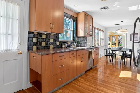 a kitchen with stainless steel appliances granite countertop a stove and cabinets
