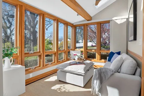 a living room with furniture and floor to ceiling windows
