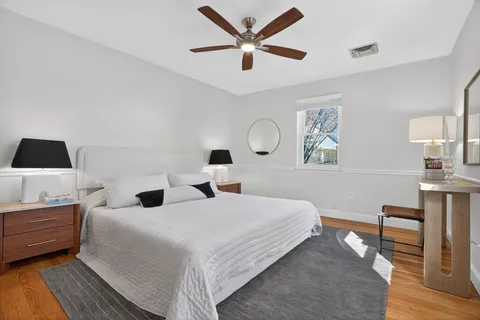a bedroom with a bed window and a table