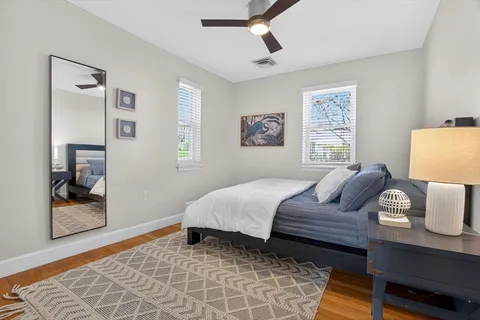 a bedroom with a bed and wooden floor