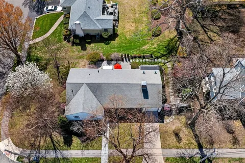 an aerial view of a house with a yard basket ball court and outdoor seating