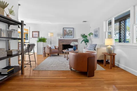 a living room with furniture a fireplace and a window