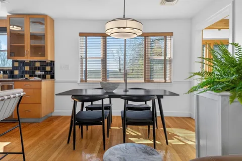 a view of a dining room with furniture window and wooden floor
