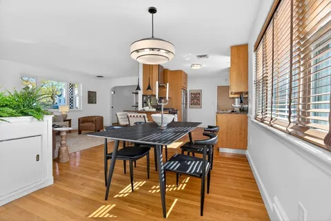 a view of a dining room with furniture window and wooden floor