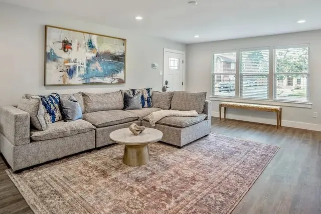 a living room with furniture and a large rug