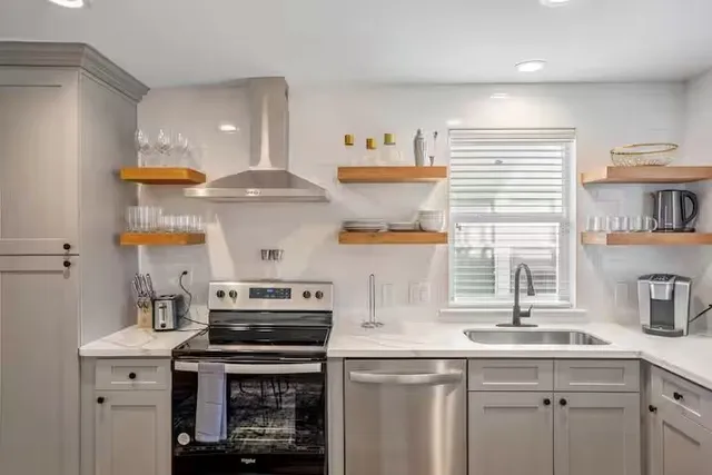 a kitchen with stainless steel appliances granite countertop a stove and a sink
