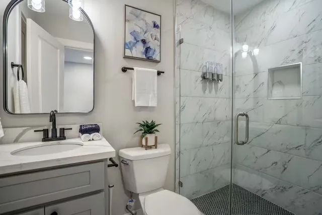 a bathroom with a toilet sink and shower