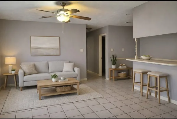 a living room with furniture and a chandelier