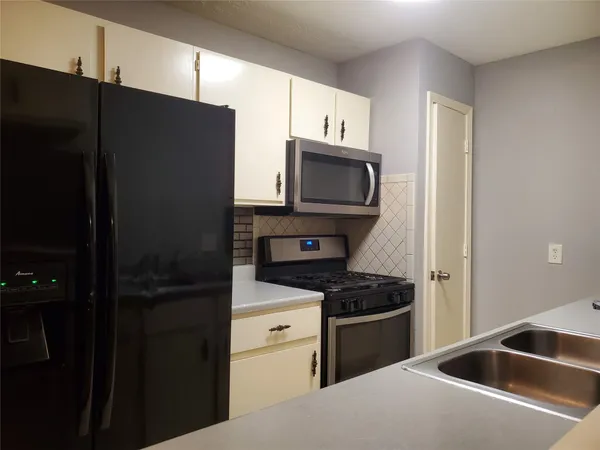 a kitchen with a refrigerator stove and microwave