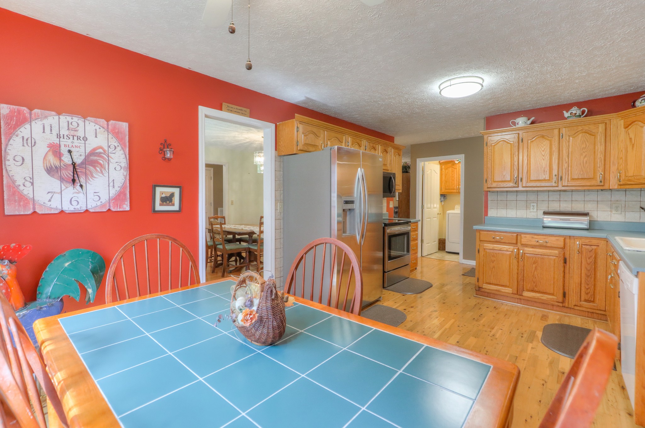 329 Shelton Road Manchester, TN 37355 - Photo 8 of 20 a kitchen with stainless steel appliances granite countertop a sink a stove top oven a dining table and chairs with wooden floor