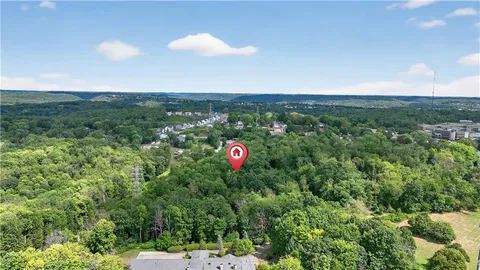 an aerial view of residential house with an outdoor space and seating