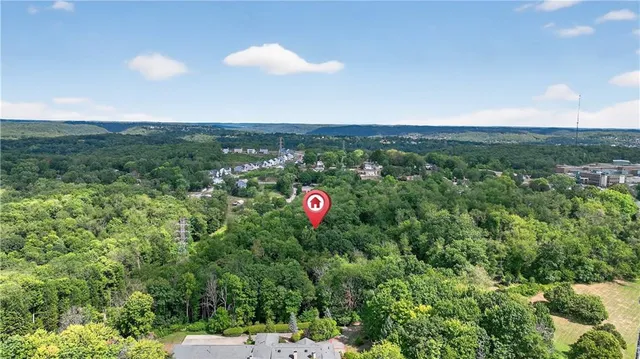 an aerial view of residential house with an outdoor space and seating