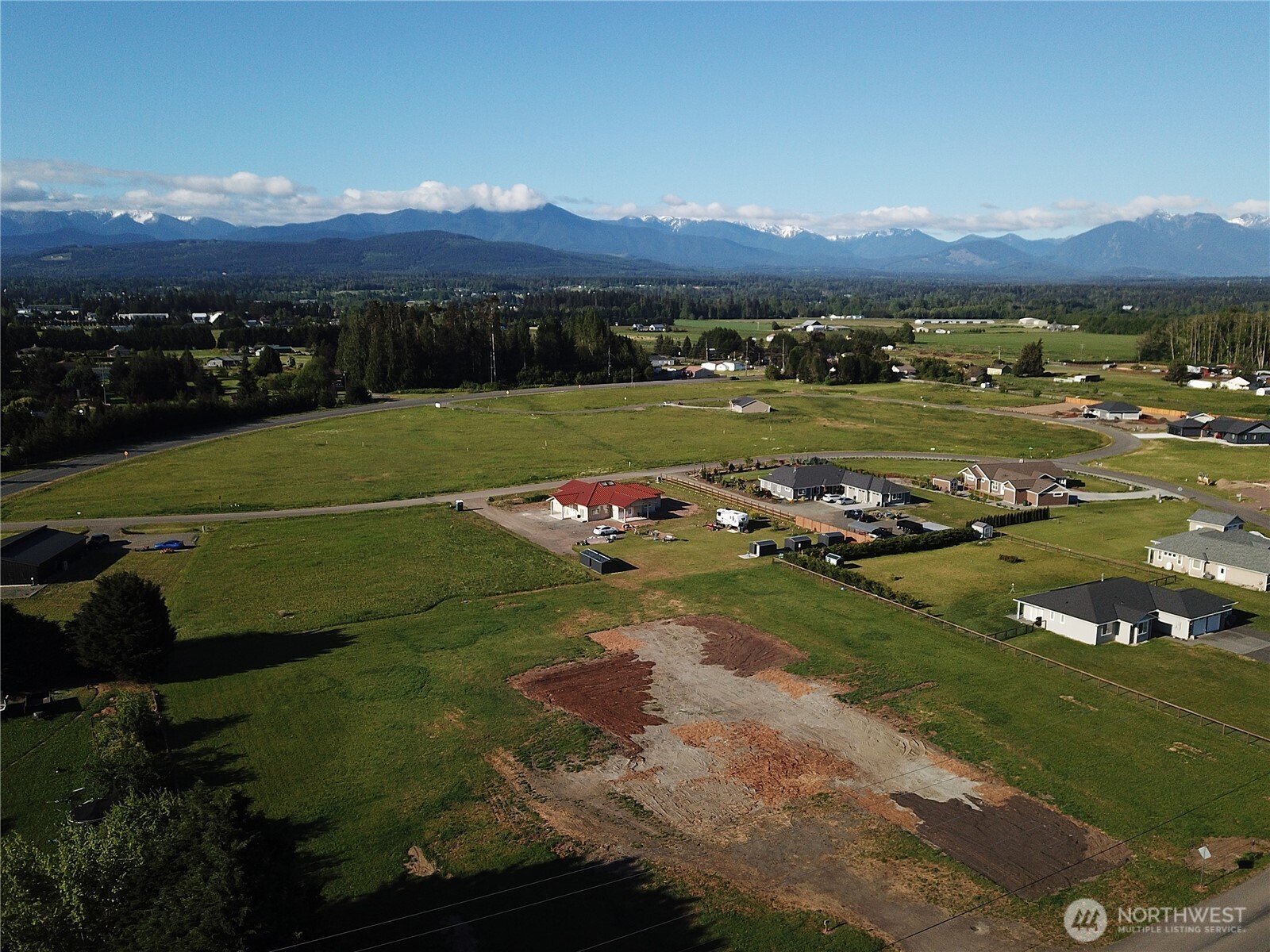 9999 Macleay Road Sequim, WA 98382 - Photo 3 of 16 a view of a grassy field with an ocean