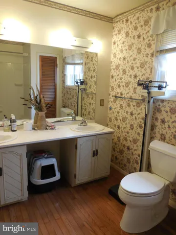 a bathroom with a double vanity sink toilet and shower