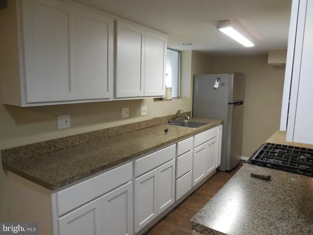 a kitchen with sink and cabinets