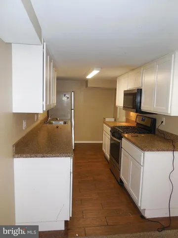 a kitchen with a sink and a refrigerator
