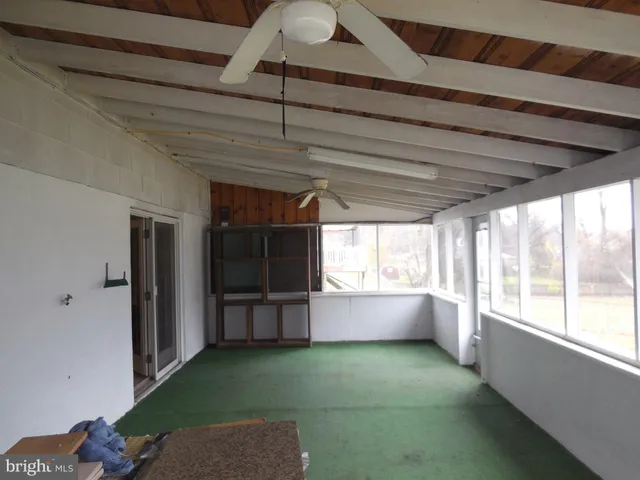 a view of a room with gym equipment and a large window