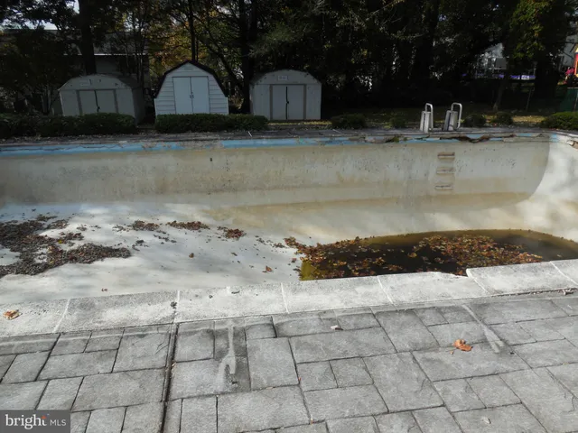 a view of a swimming pool with a yard