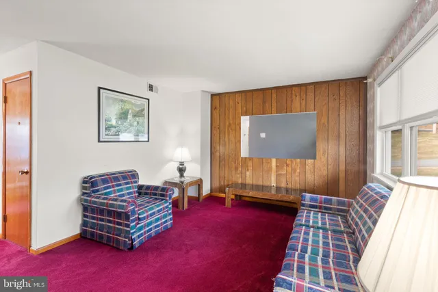 a living room with furniture and a pool