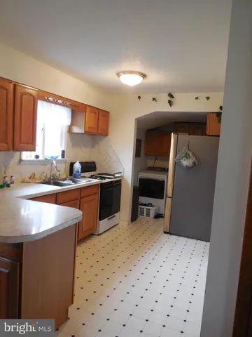 a kitchen with stainless steel appliances kitchen island granite countertop a sink and a stove