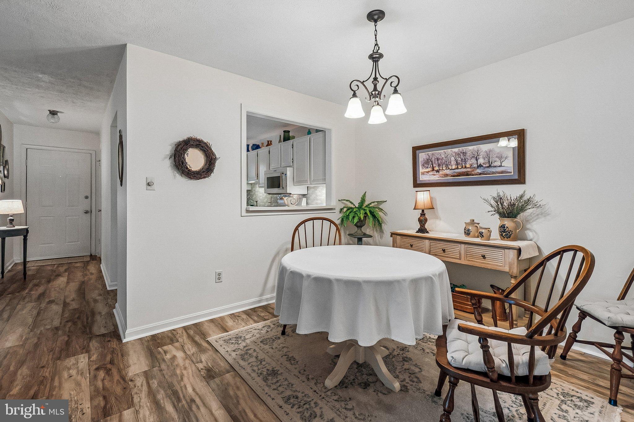 10090 Oakton Terrace Road Oakton, VA 22124 - Photo 13 of 25 a view of a dining room with furniture and chandelier
