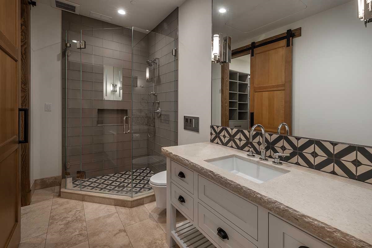 8249 Ehrman Drive Truckee, CA 96161 - Photo 12 of 21 a bathroom with a sink a shower a mirror and a bathtub