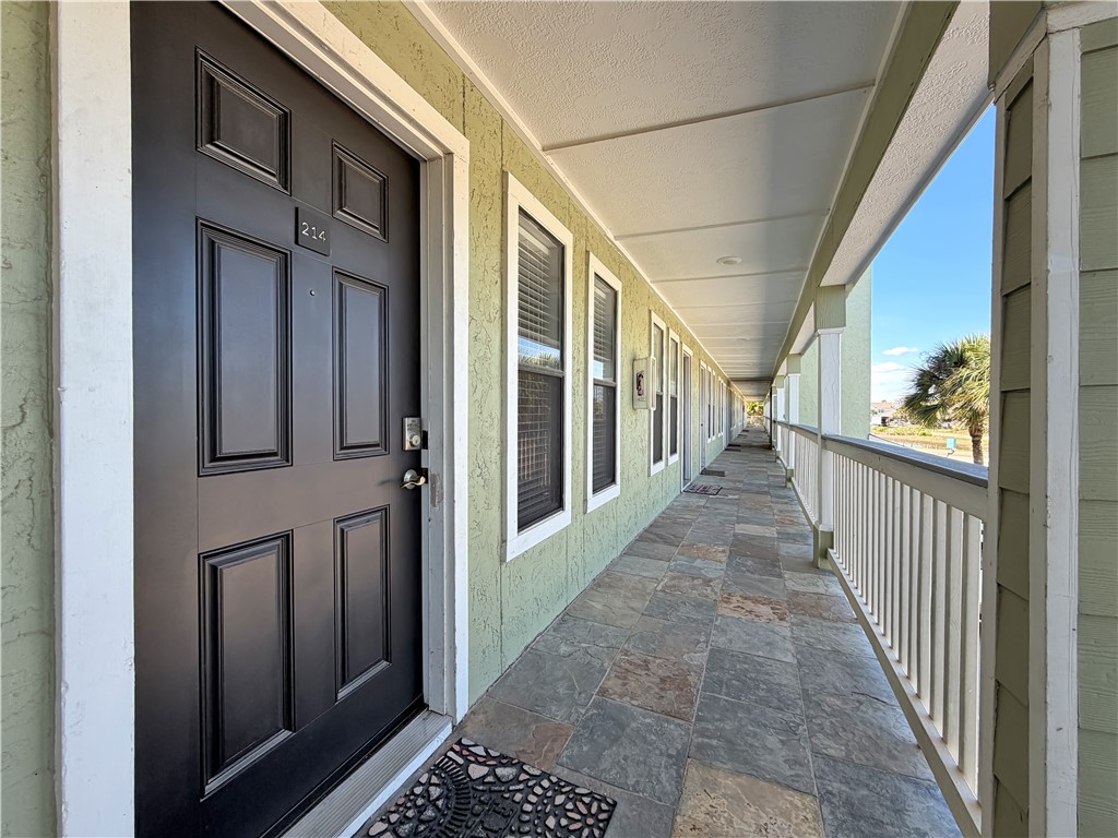 2290 North Fulton Beach Road, Unit 214 Rockport, TX 78382 - Photo 18 of 29 a view of a porch with wooden floor and stairs