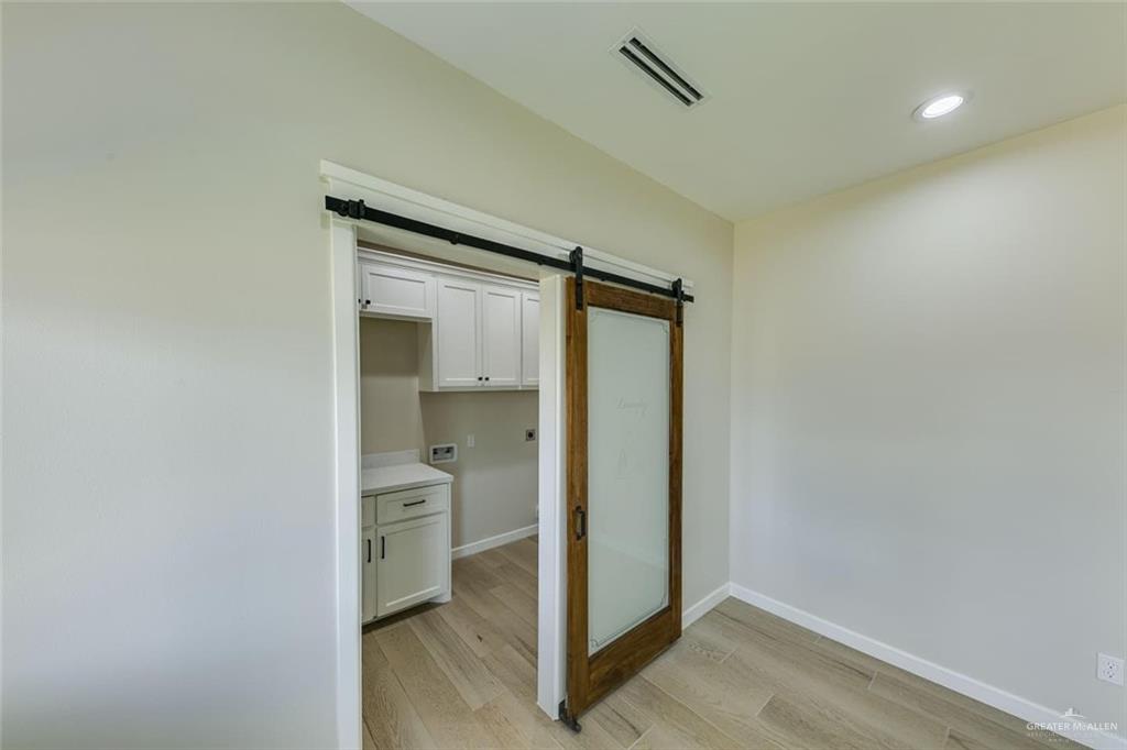 910 Trinity Street Alamo, TX 78516 - Photo 7 of 12 a view of room with a hallway