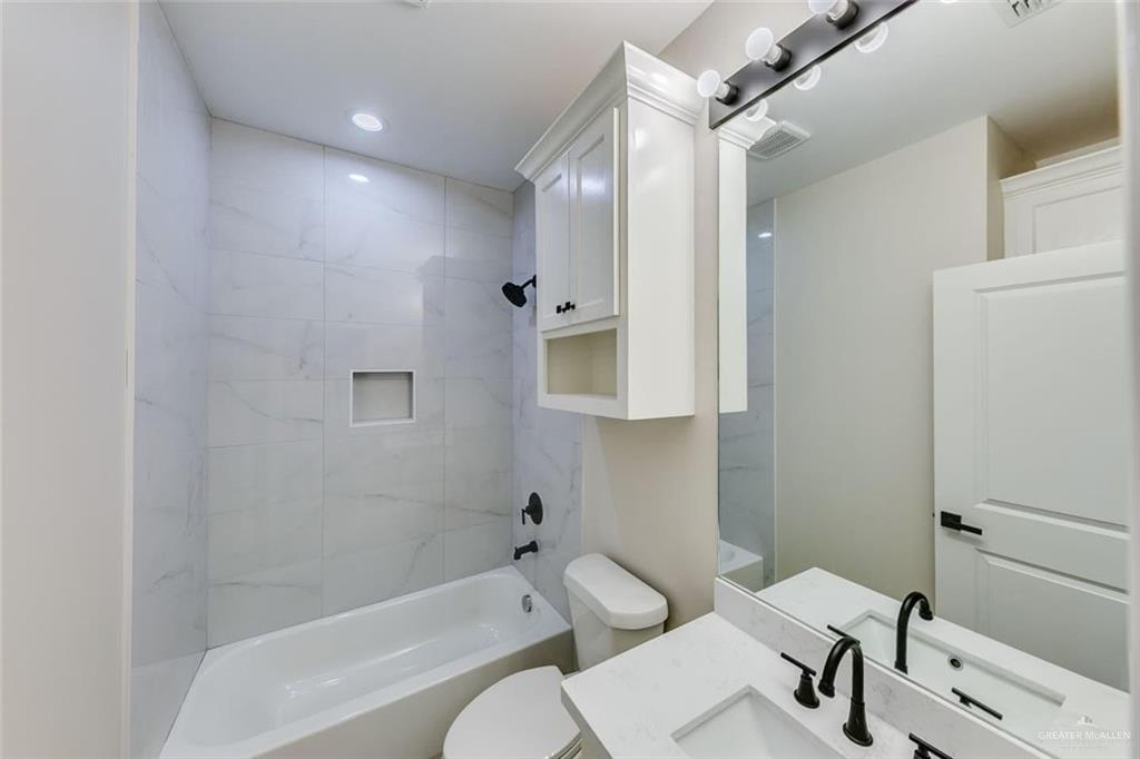 910 Trinity Street Alamo, TX 78516 - Photo 10 of 12 a bathroom with a sink a toilet and shower