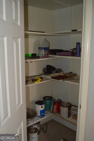 a kitchen with a refrigerator and cabinets