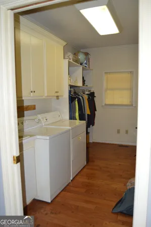 a bedroom with a bed window and a mirror