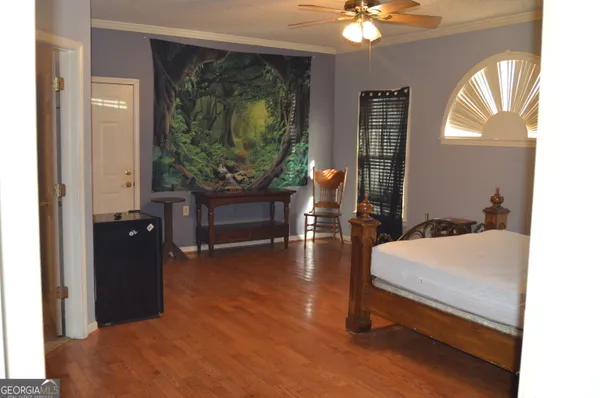 a living room with furniture and wooden floor