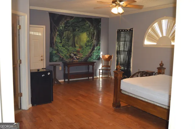 a living room with furniture and wooden floor