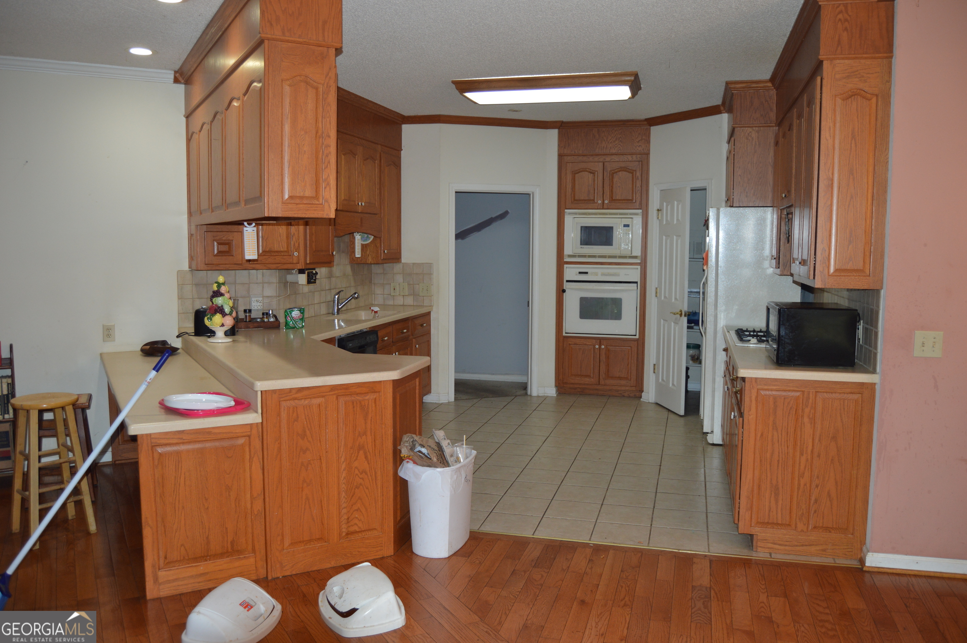 424 Law House Road Toccoa, GA 30577 - Photo 8 of 38 a kitchen with a sink and wooden cabinets