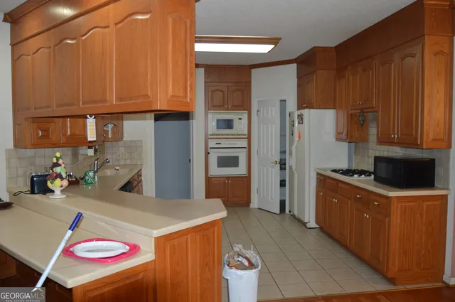 a kitchen with stainless steel appliances granite countertop a refrigerator stove and sink