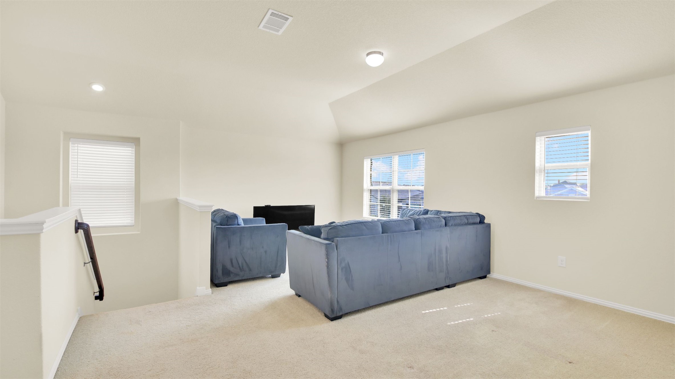 13716 Sugar Bush Path Manor, TX 78653 - Photo 25 of 37 Living room featuring light carpet and lofted ceiling