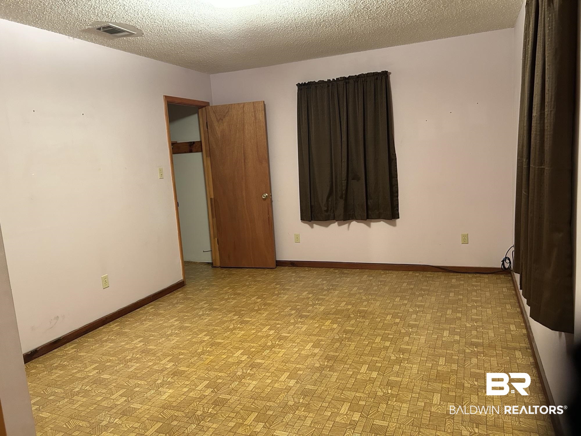 1350 A Schillinger Road South Mobile, AL 36695 - Photo 11 of 18 Unfurnished room with a textured ceiling and light floors