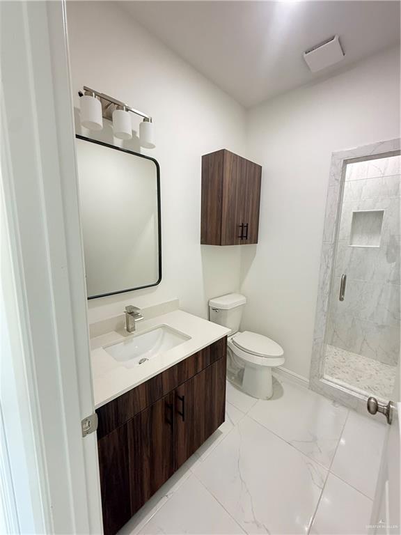 5333 Vision Street Rio Grande City, TX 78582 - Photo 3 of 7 a bathroom with a toilet sink and mirror