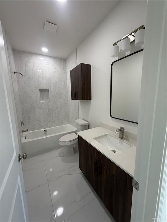 5333 Vision Street Rio Grande City, TX 78582 - Photo 4 of 7 a bathroom with a double vanity sink toilet mirror and shower