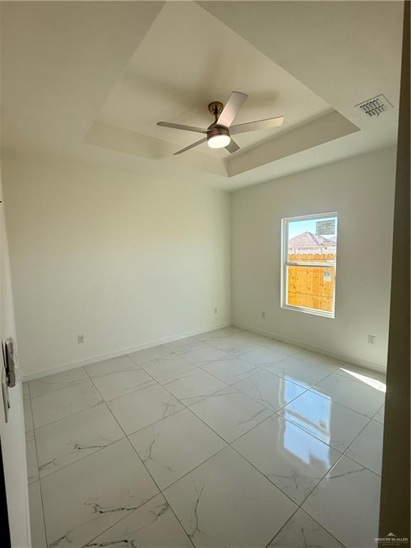 5333 Vision Street Rio Grande City, TX 78582 - Photo 5 of 7 en empty room with windows and fan