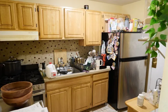 a kitchen with a refrigerator and a sink
