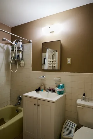 a bathroom with a sink mirror vanity and toilet